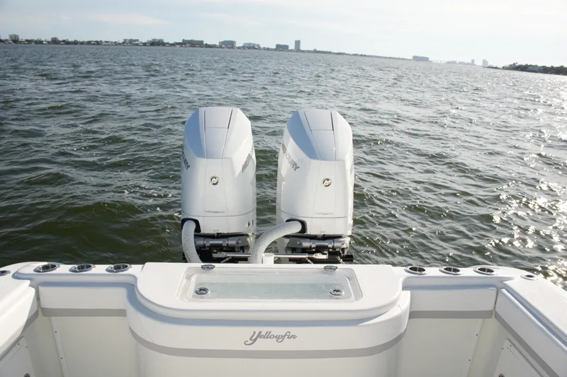 Slide: The Image of 2014 Yellowfin 32 Offshore boat with dual Mercury engines on open water. - 27
