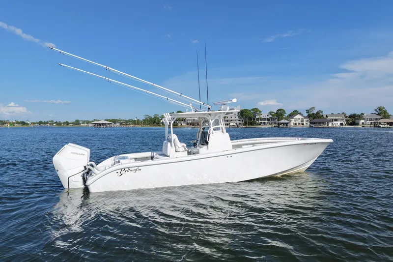 Slide: The Image of 2014 Yellowfin 32 Offshore boat on calm water, clear sky background. - 18