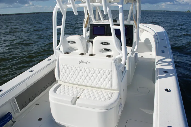 Slide: The Image of 2014 Yellowfin 32 Offshore boat with white seating and ocean backdrop. - 33