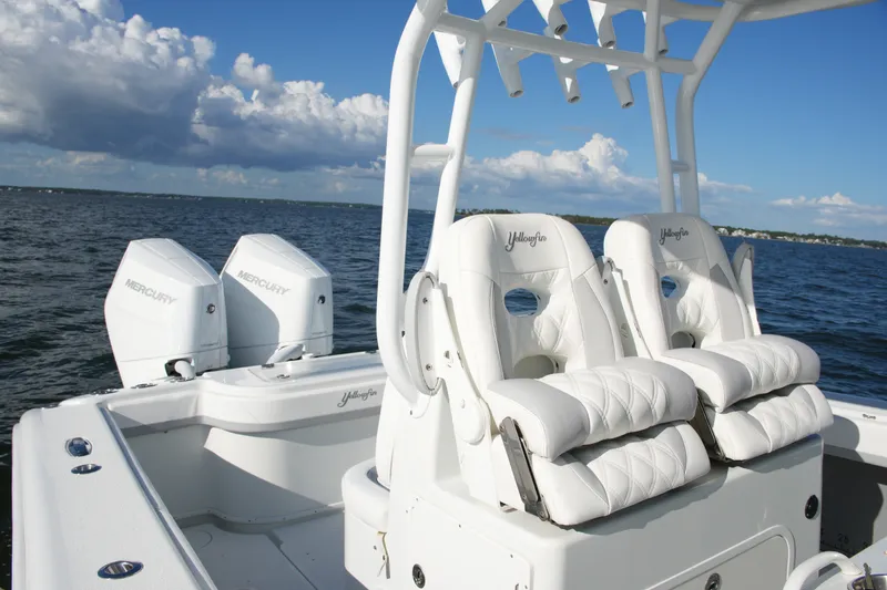 Slide: The Image of 2014 Yellowfin 32 Offshore boat with dual Mercury engines and plush seating on open water. - 41