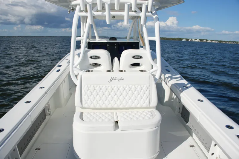 Slide: The Image of 2014 Yellowfin 32 Offshore boat with white seating, on open water under a blue sky. - 34