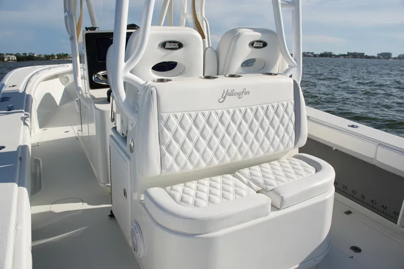 Slide: The Image of 2014 Yellowfin 32 Offshore boat with white quilted seating on open water. - 52