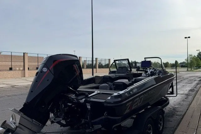 Slide: The Image of 2024 Nitro ZV20 boat parked outdoors, showcasing sleek design and powerful engine. - 10