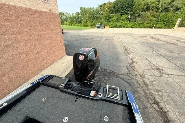 Slide: The Image of 2024 Nitro ZV20 boat with powerful outboard motor in a parking lot. - 16