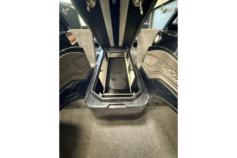 Slide: The Image of 2024 Nitro ZV20 boat storage compartment with open lid, showcasing interior space. - 21
