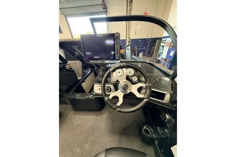 Slide: The Image of Interior of 2024 Nitro ZV20 boat with steering wheel and navigation display. - 22