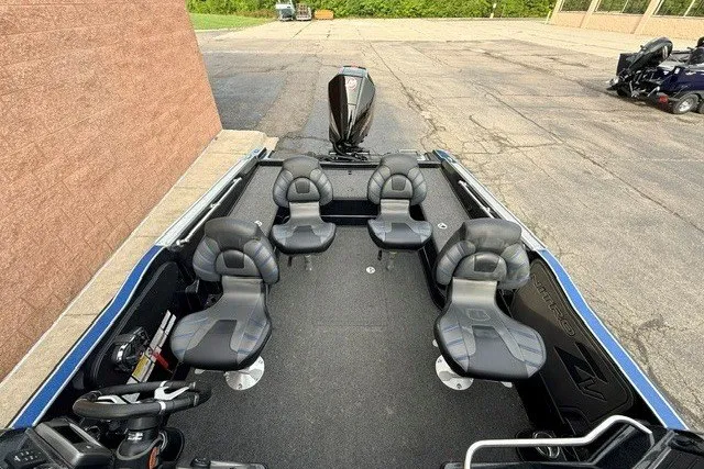 Slide: The Image of 2024 Nitro ZV20 boat with six seats, parked on pavement near a brick wall. - 17