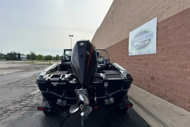 Slide: The Image of 2024 Nitro ZV20 boat with powerful outboard motor, parked near a marina sign. - 9