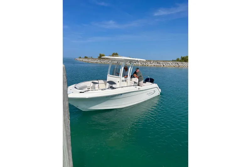 The Image of 2019 Robalo R222 Explorer boat cruising in clear blue waters. - 0