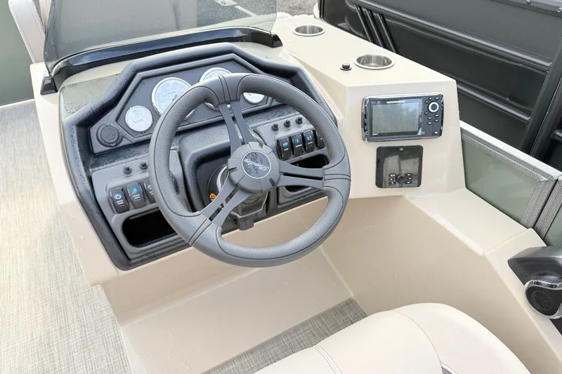 Slide: The Image of 2027 Bentley Pontoons Fish 220 FWD CW dashboard with steering wheel and navigation controls. - 11