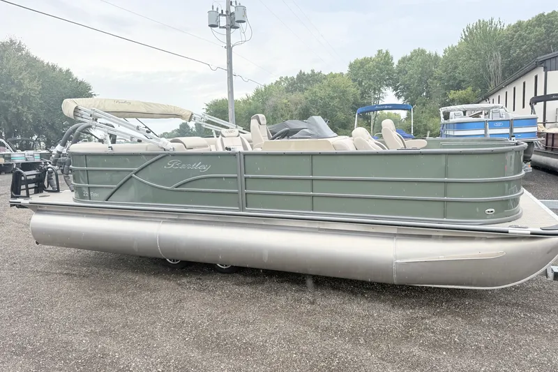 Slide: The Image of 2027 Bentley Pontoons Fish 220 FWD CW pontoon boat on display outdoors. - 16