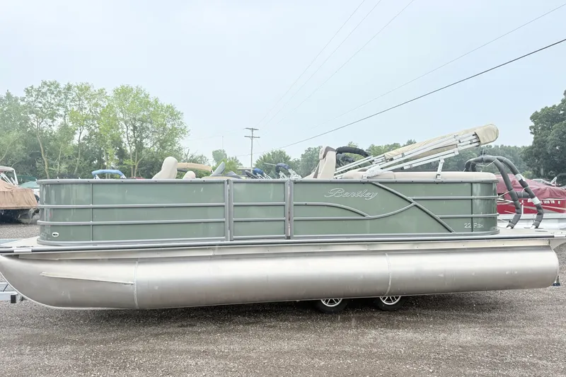 Slide: The Image of 2027 Bentley Pontoons Fish 220 FWD CW, green pontoon boat, parked outdoors. - 3