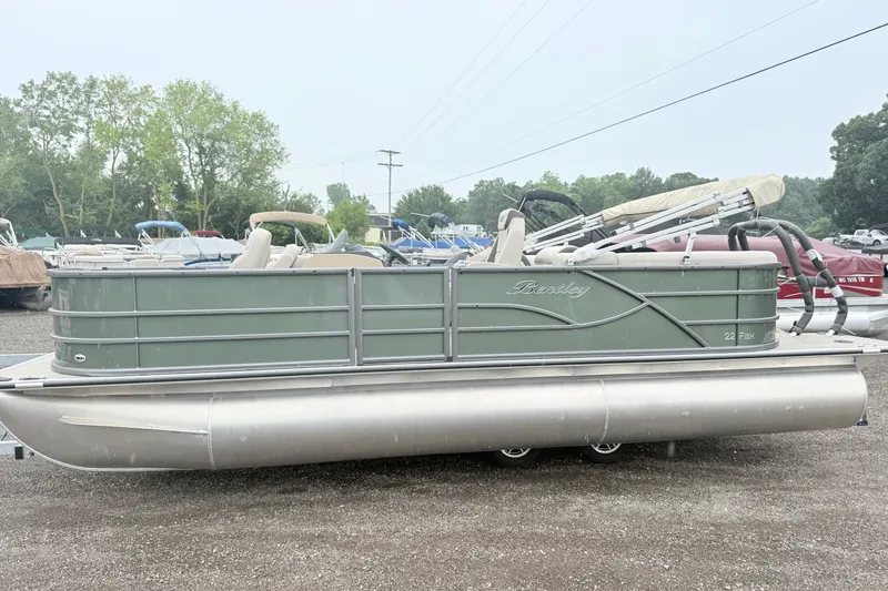 The Image of A 2027 Bentley Pontoons Fish 220 FWD CW on a trailer in an outdoor lot. - 0