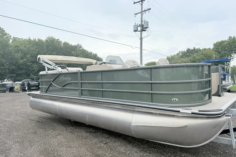 Slide: The Image of 2027 Bentley Pontoons Fish 220 FWD CW pontoon boat in outdoor setting. - 2