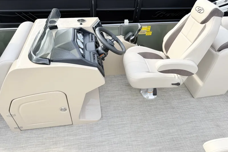 Slide: The Image of 2027 Bentley Pontoons Fish 220 FWD CW helm with beige captain's chair and dashboard. - 8