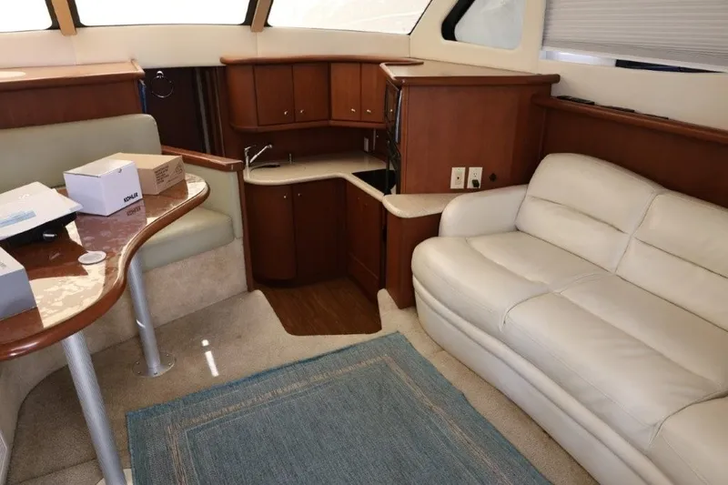 Slide: The Image of Interior of 2005 Silverton 34 Convertible yacht with cozy seating and kitchenette. - 13
