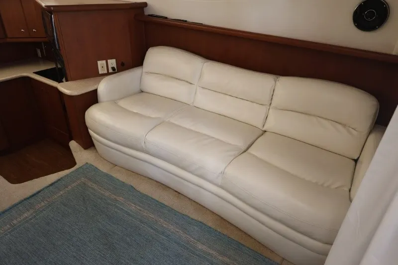 Slide: The Image of Luxurious interior of 2005 Silverton 34 Convertible yacht with white leather sofa. - 11