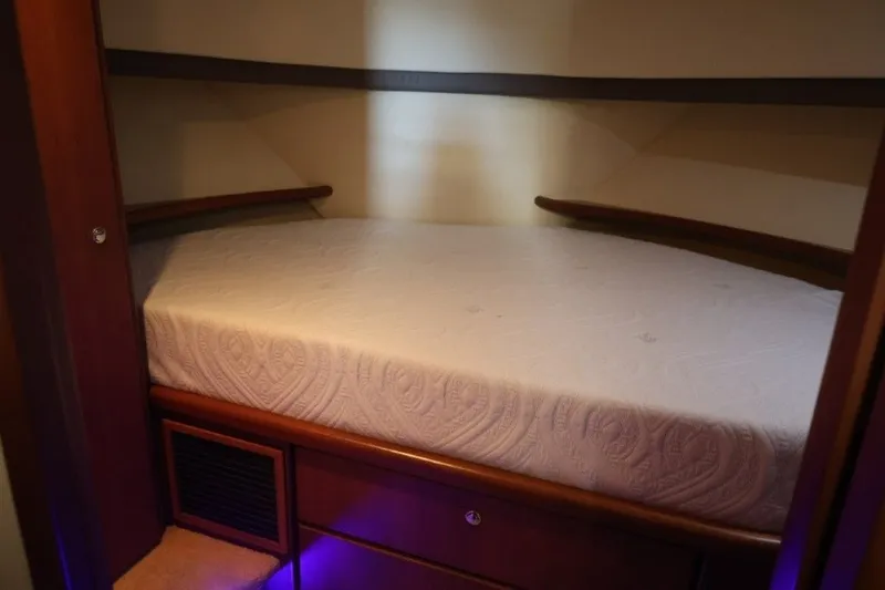 Slide: The Image of Interior cabin bed of 2005 Silverton 34 Convertible yacht with elegant wood finish. - 14