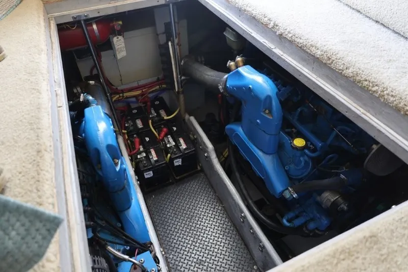 Slide: The Image of Engine compartment of a 2005 Silverton 34 Convertible boat, featuring blue engines and batteries. - 9