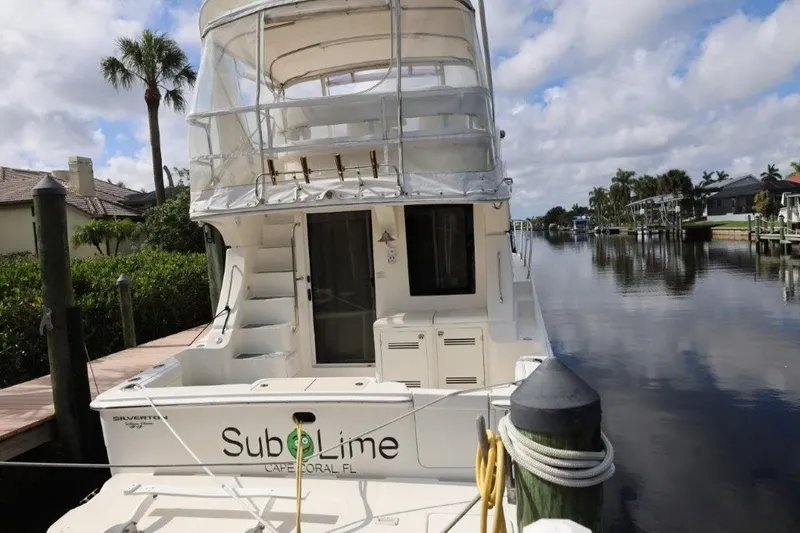 Slide: The Image of 2005 Silverton 34 Convertible docked in Cape Coral, Florida, with clear skies and palm trees. - 8