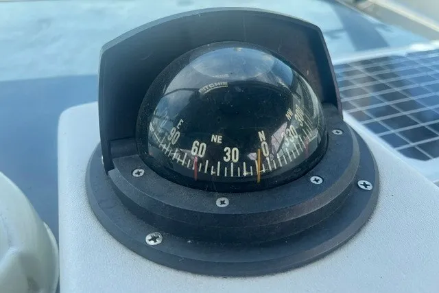 Slide: The Image of Compass on 1989 Sea Ray 300 Weekender boat, showing navigational directions. - 15