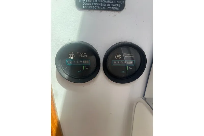 Slide: The Image of Engine hour meters on a 1989 Sea Ray 300 Weekender boat dashboard. - 30