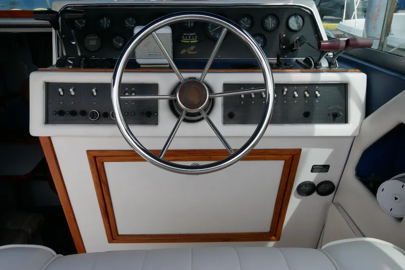 Slide: The Image of Cockpit of 1989 Sea Ray 300 Weekender with steering wheel and control panel. - 10