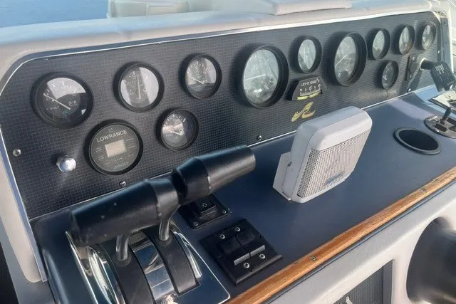 Slide: The Image of Control panel of a 1989 Sea Ray 300 Weekender boat with gauges and controls. - 14