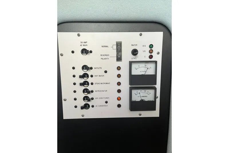 Slide: The Image of Control panel of a 1989 Sea Ray 300 Weekender boat with switches and gauges. - 27