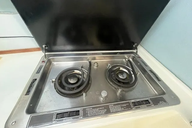 Slide: The Image of 1989 Sea Ray 300 Weekender boat stove with dual burners and alcohol fuel system. - 25