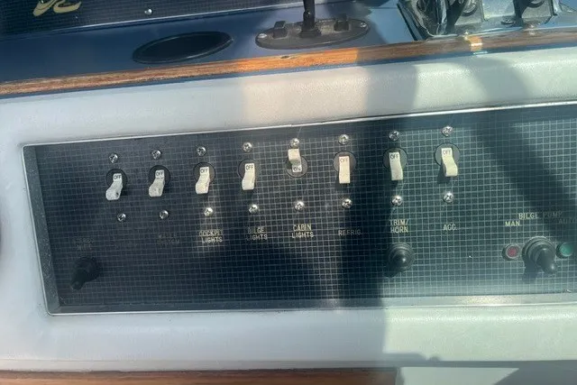 Slide: The Image of Control panel of a 1989 Sea Ray 300 Weekender boat with various switches. - 11