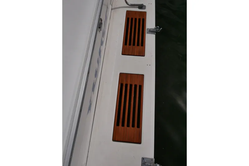 Slide: The Image of 1989 Sea Ray 300 Weekender boat deck with wooden vent covers. - 35