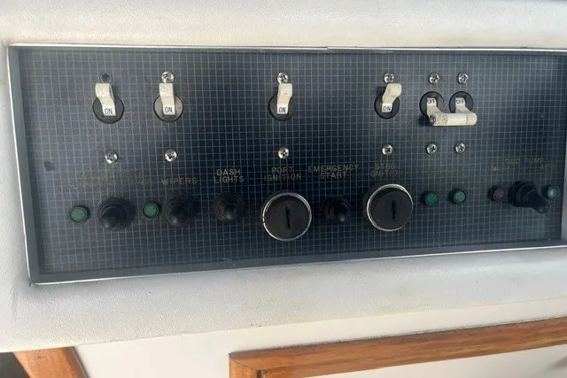 Slide: The Image of Control panel of a 1989 Sea Ray 300 Weekender boat with switches and dials. - 12