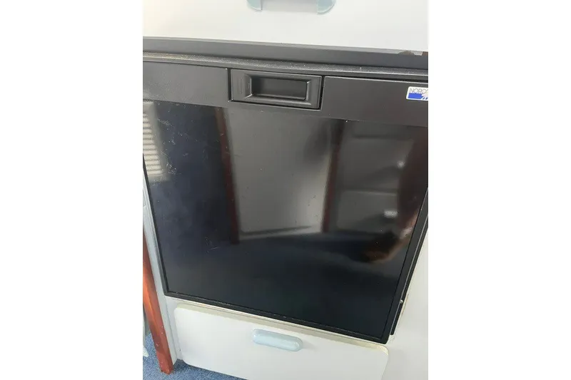 Slide: The Image of Black refrigerator inside 1989 Sea Ray 300 Weekender boat cabin. - 24
