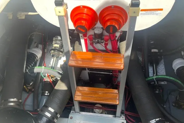 Slide: The Image of Engine compartment of a 1989 Sea Ray 300 Weekender with visible components and ladder. - 34