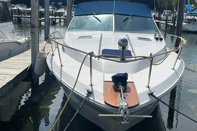 Slide: The Image of 1989 Sea Ray 300 Weekender docked at a marina, front view. - 1