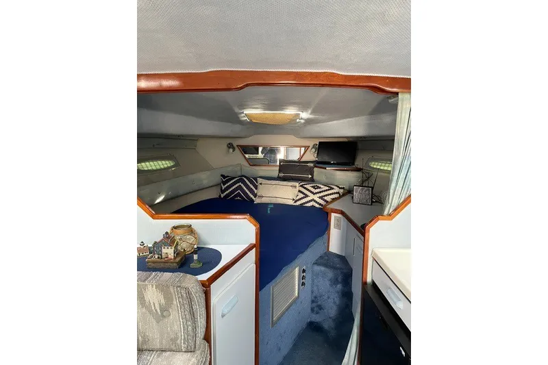 Slide: The Image of Interior of 1989 Sea Ray 300 Weekender boat with cozy cabin and blue bedding. - 16