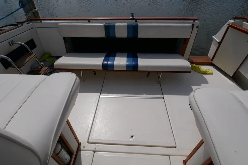 Slide: The Image of 1989 Sea Ray 300 Weekender boat interior with white seating and blue accents. - 8