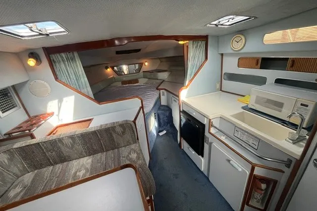 Slide: The Image of Interior of a 1989 Sea Ray 300 Weekender boat with kitchen and sleeping area. - 17