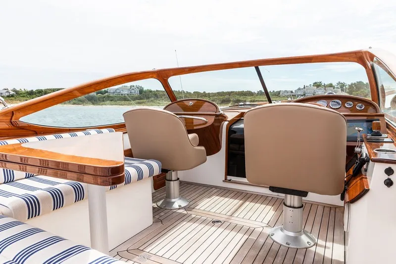 Slide: The Image of 2025 Hinckley Yachts Talaria 29 Runabout interior with elegant seating and wooden accents. - 12