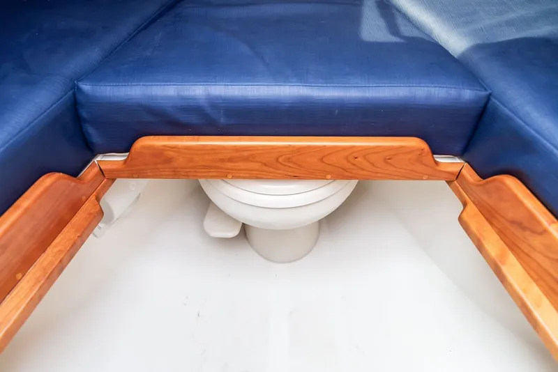 Slide: The Image of Interior of 2025 Hinckley Talaria 29 Runabout, featuring a compact marine toilet. - 21