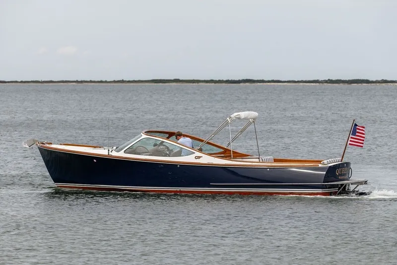 Slide: The Image of 2025 Hinckley Yachts Talaria 29 Runabout cruising on open water with American flag. - 27