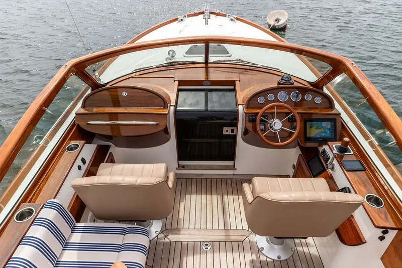 Slide: The Image of Luxurious 2025 Hinckley Talaria 29 Runabout yacht interior with elegant wood finish and modern controls. - 10