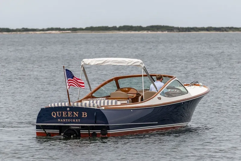 Slide: The Image of 2025 Hinckley Yachts Talaria 29 Runabout on water, American flag, Nantucket. - 30