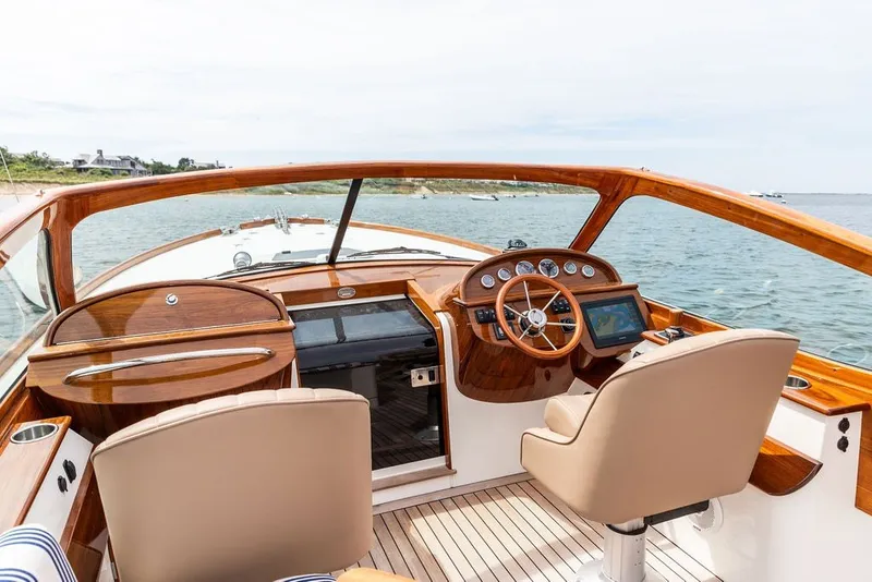 Slide: The Image of 2025 Hinckley Yachts Talaria 29 Runabout interior with elegant wood finish and modern controls. - 9
