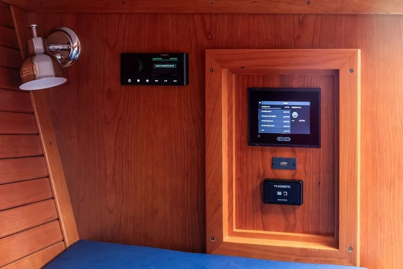 Slide: The Image of Interior of 2025 Hinckley Yachts Talaria 29 Runabout with control panels and wooden finish. - 22