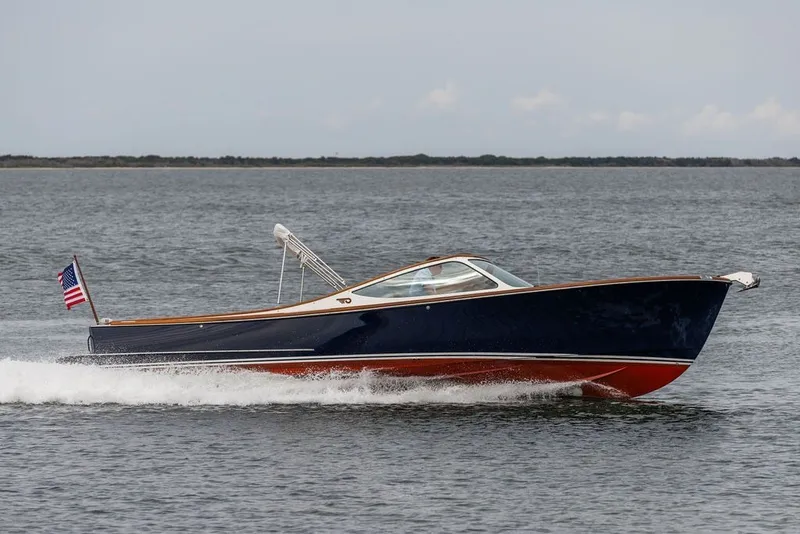 Slide: The Image of 2025 Hinckley Yachts Talaria 29 Runabout cruising on open water. - 32