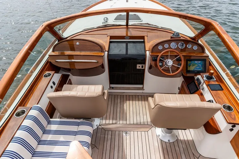 Slide: The Image of Luxurious 2025 Hinckley Talaria 29 Runabout yacht interior with elegant wood and leather finishes. - 1