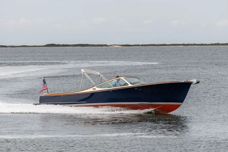 Slide: The Image of 2025 Hinckley Yachts Talaria 29 Runabout cruising on open water, displaying sleek design and elegance. - 33