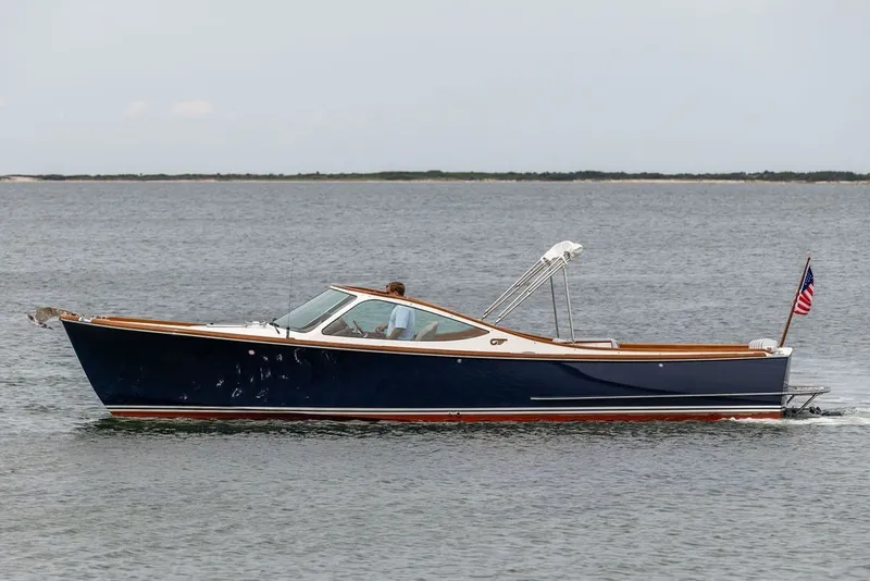 Slide: The Image of 2025 Hinckley Yachts Talaria 29 Runabout cruising on open water. - 26